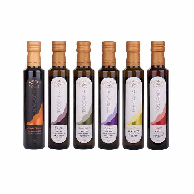 Set of six olive oil bottles with various flavours on a white background