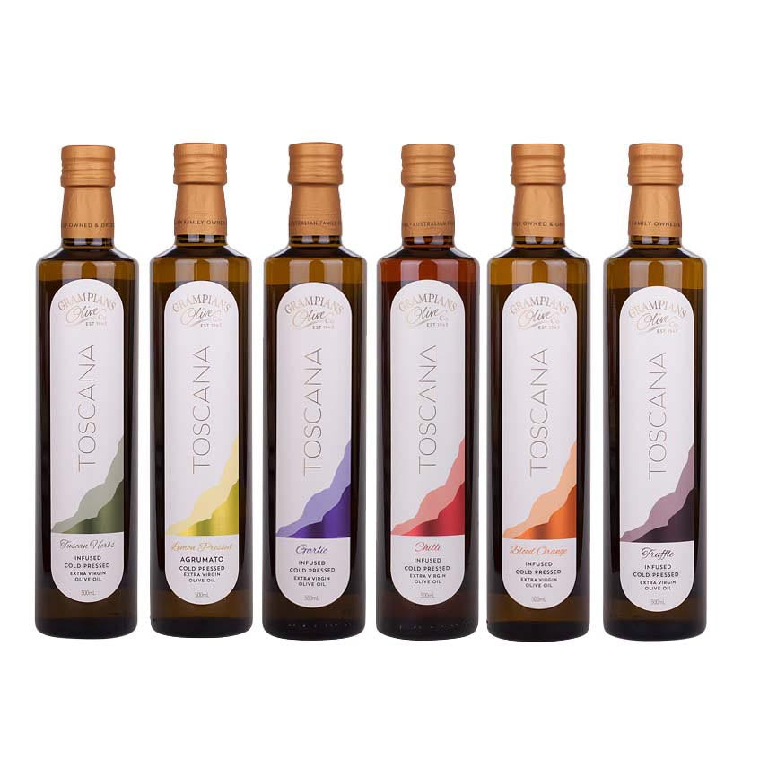 Set of six olive oil bottles with varying label designs on a white background