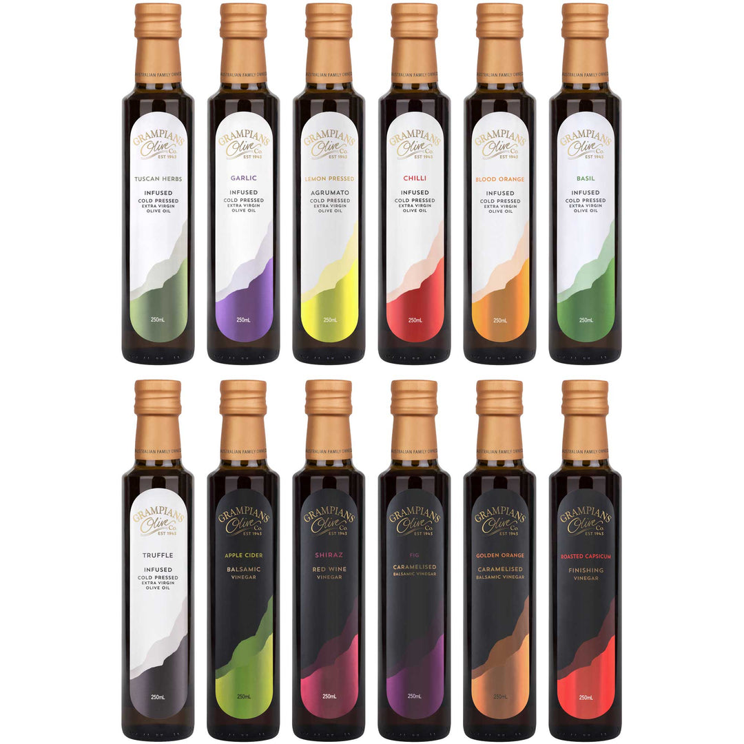 Set of 12 bottles of Grampians Olive Co Infused Olive Oils and balsamic vinegars in various flavors on a white background