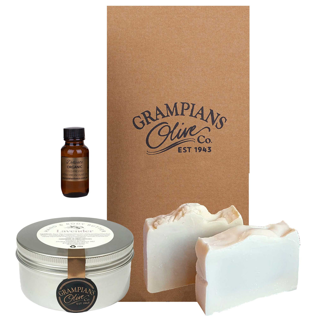Grampians Olive Co skincare products including a bottle of organic oil, tin of lotion, and olive oils soap bars with a branded box.