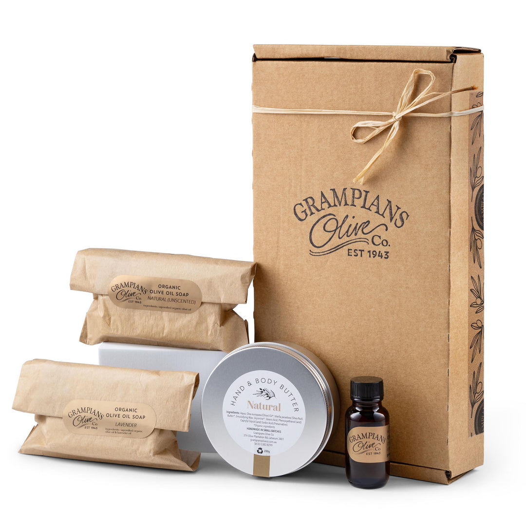 Grampians Olive Co skincare products including a bottle of organic oil, tin of lotion, and olive oils soap bars with a branded box.